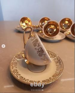 A stunning tea set including cups and saucers with a luxurious gold finish. The