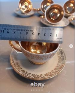 A stunning tea set including cups and saucers with a luxurious gold finish. The