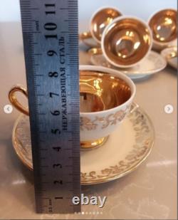 A stunning tea set including cups and saucers with a luxurious gold finish. The