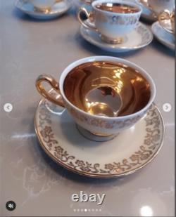 A stunning tea set including cups and saucers with a luxurious gold finish. The