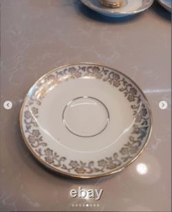 A stunning tea set including cups and saucers with a luxurious gold finish. The