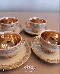 A stunning tea set including cups and saucers with a luxurious gold finish. The