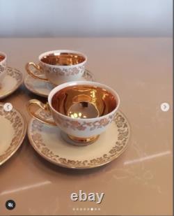 A stunning tea set including cups and saucers with a luxurious gold finish. The
