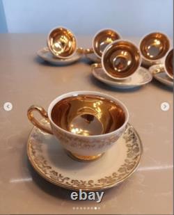 A stunning tea set including cups and saucers with a luxurious gold finish. The