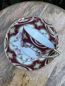 Hand-painted Nippon porcelain teacup and saucer with floral and gold decoration