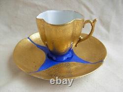 LIMOGES GILDED AND HAND PAINTED PORCELAIN CUP AND SAUCER, 20th CENTURY