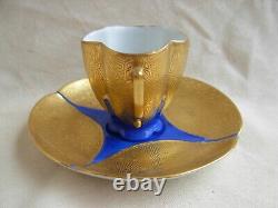 LIMOGES GILDED AND HAND PAINTED PORCELAIN CUP AND SAUCER, 20th CENTURY