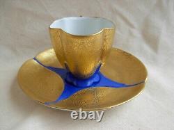 LIMOGES GILDED AND HAND PAINTED PORCELAIN CUP AND SAUCER, 20th CENTURY