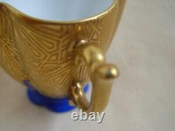 LIMOGES GILDED AND HAND PAINTED PORCELAIN CUP AND SAUCER, 20th CENTURY