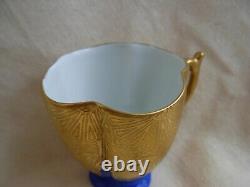 LIMOGES GILDED AND HAND PAINTED PORCELAIN CUP AND SAUCER, 20th CENTURY