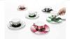 Mirror Teacups Reflect Colorful Patterns From The Saucers They Re Placed On
