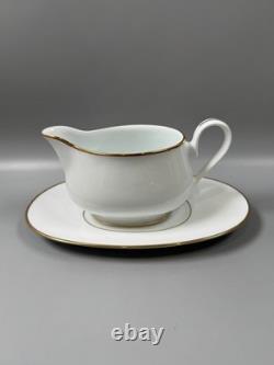 Set of classic Noritake P589 dinner ware for six white with gold rim and gold